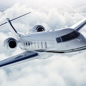 Light private jet flying above clouds